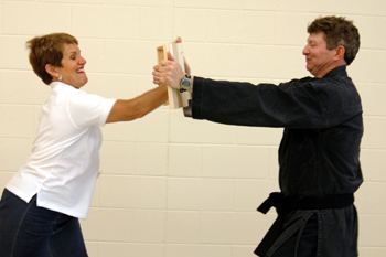 Mayor Jody Smith board-breaking at a community self-defense seminar for kids.